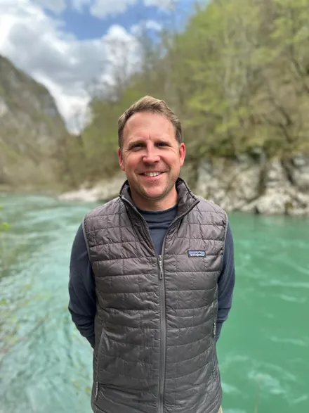 Matt Niemitz smiling beside a turquoise river